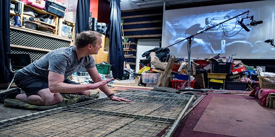 Foley artist testing materials in a sound studio beside recording equipment